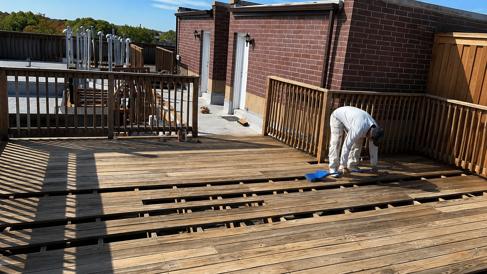 Professional carpenter repairing damaged wood deck boards in Chicago