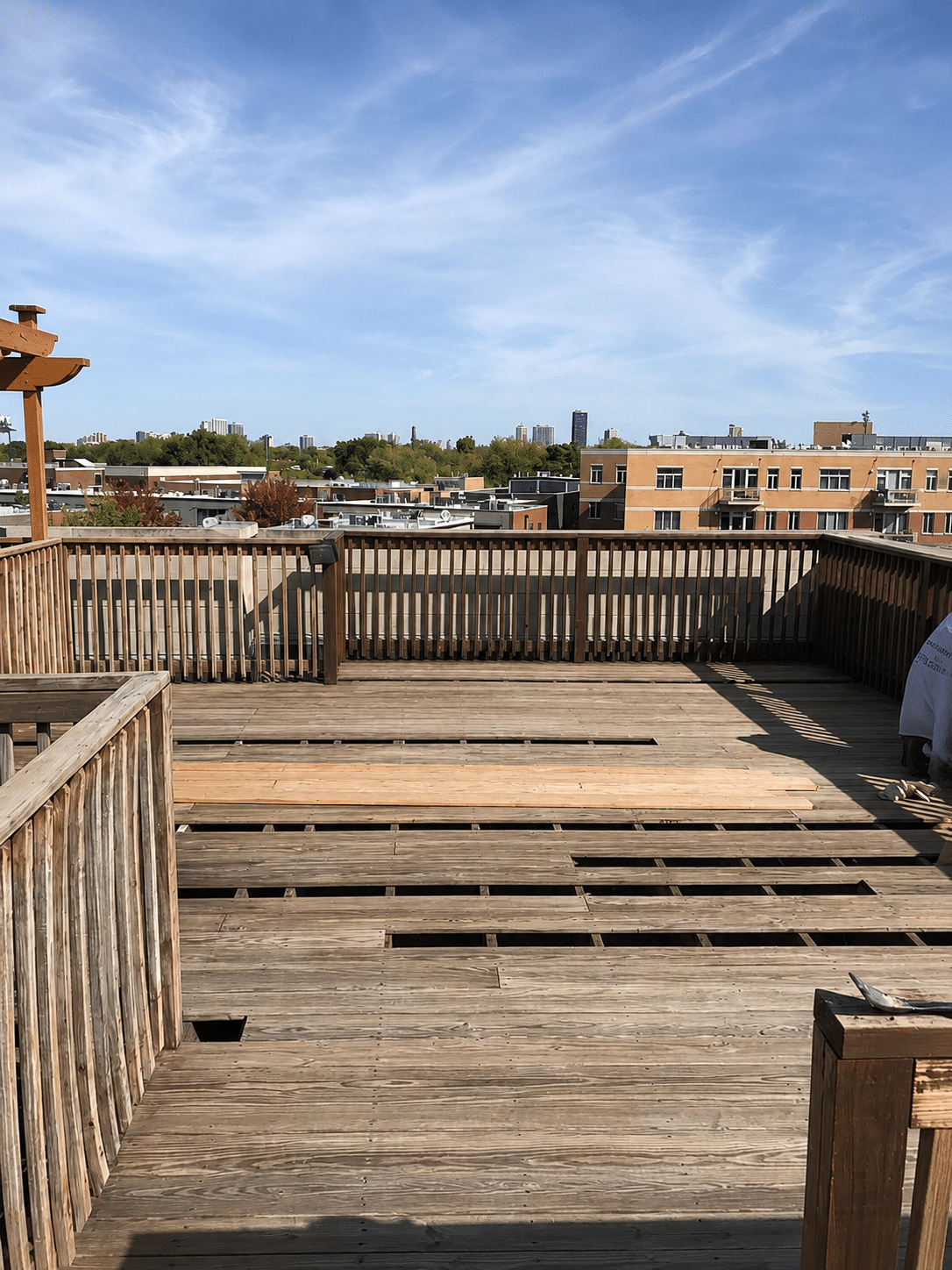 Wood rooftop deck undergoing professional carpentry repairs in Chicago