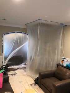 A living room under construction with plastic protection