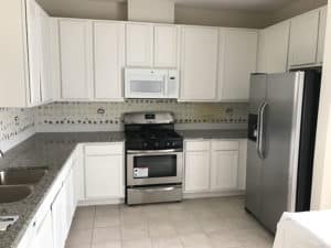 White cabinets with tile flooring