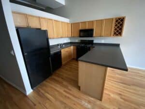 Black countertops with brown kitchen cabinets