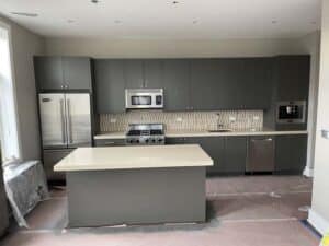 Grey cabinets in unfinished kitchen