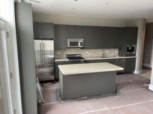 Grey cabinets in unfinished kitchen